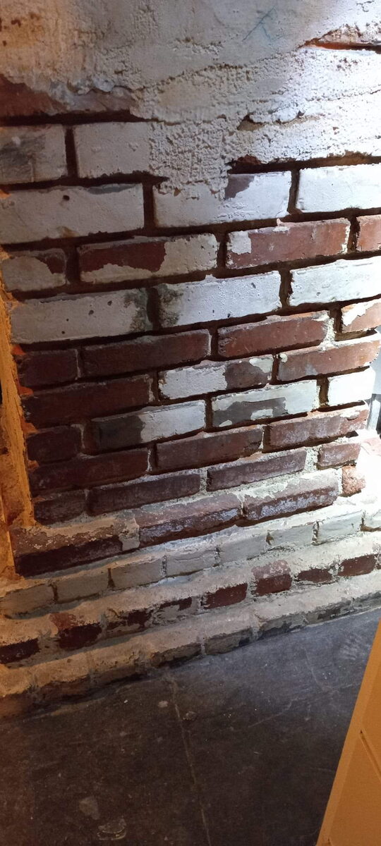 Close-up of crumbling mortar joints in an Omaha brick foundation